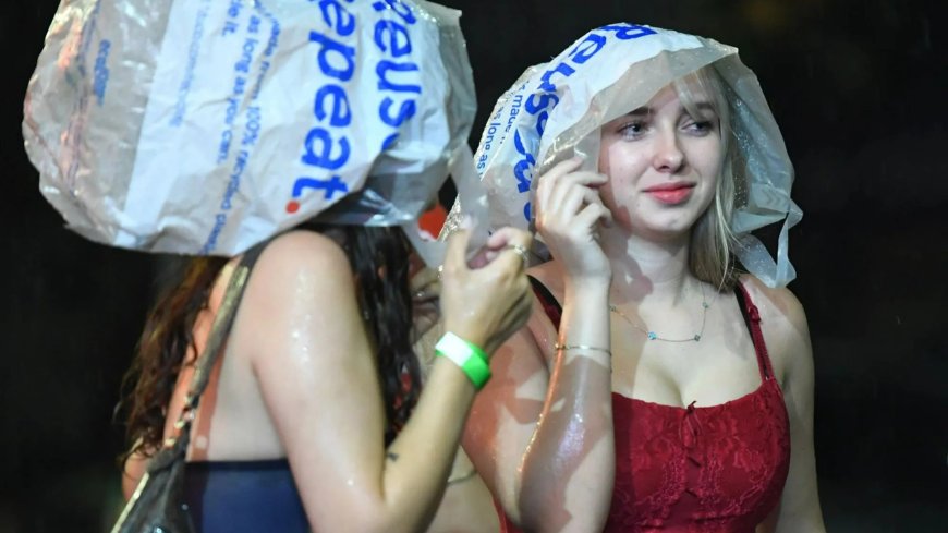 Freshers use carrier bags as makeshift umbrellas & dodge huge puddles on big night out in pouring rain --[Reported by Umva mag]